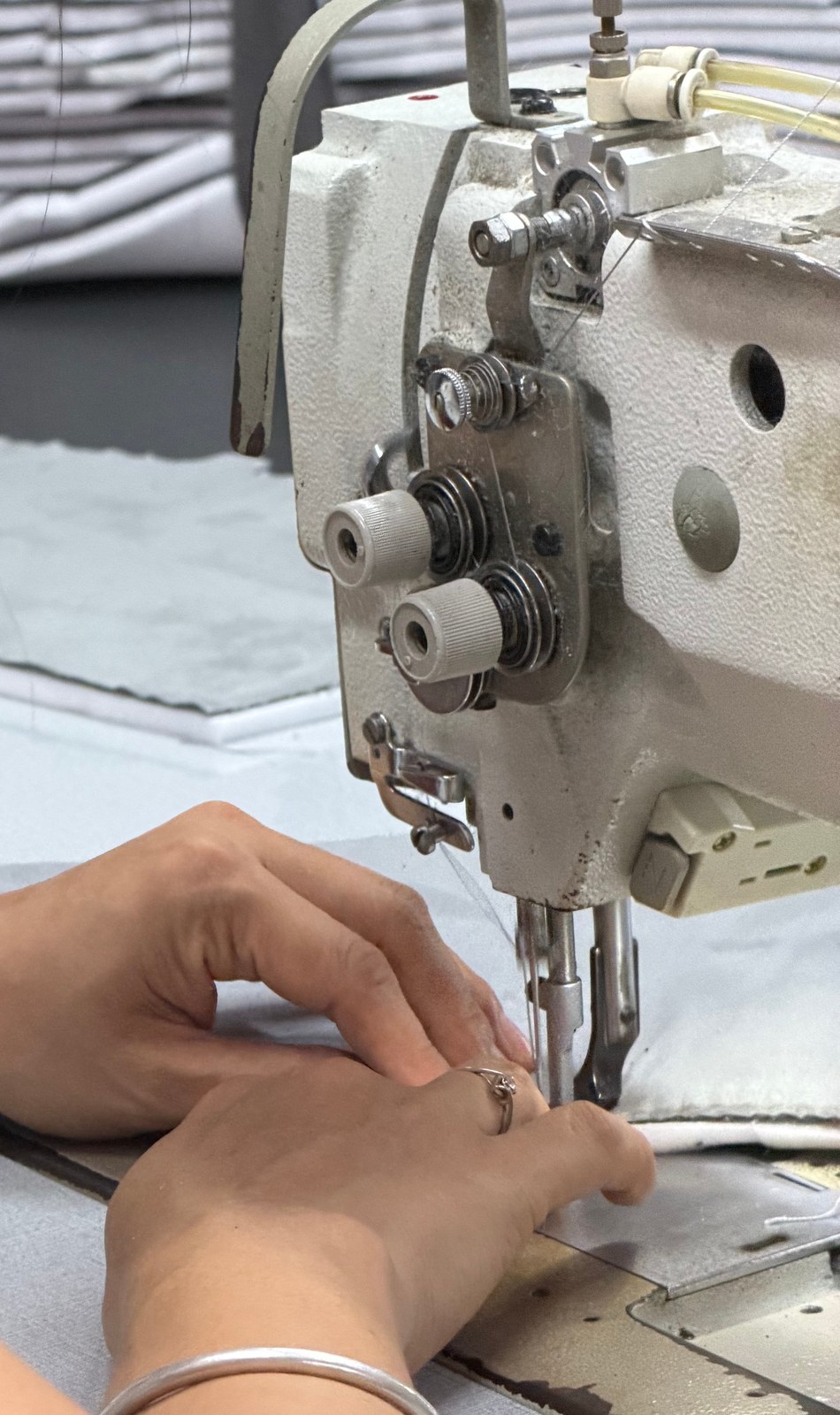 Close-up of an upholstery seam being sewn in the Lenatees factory