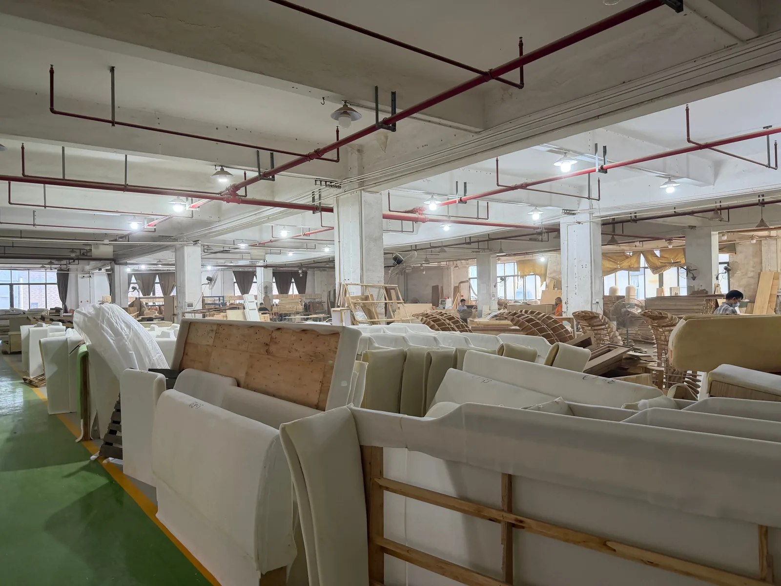 Rows of custom sofas progressing through upholstery production