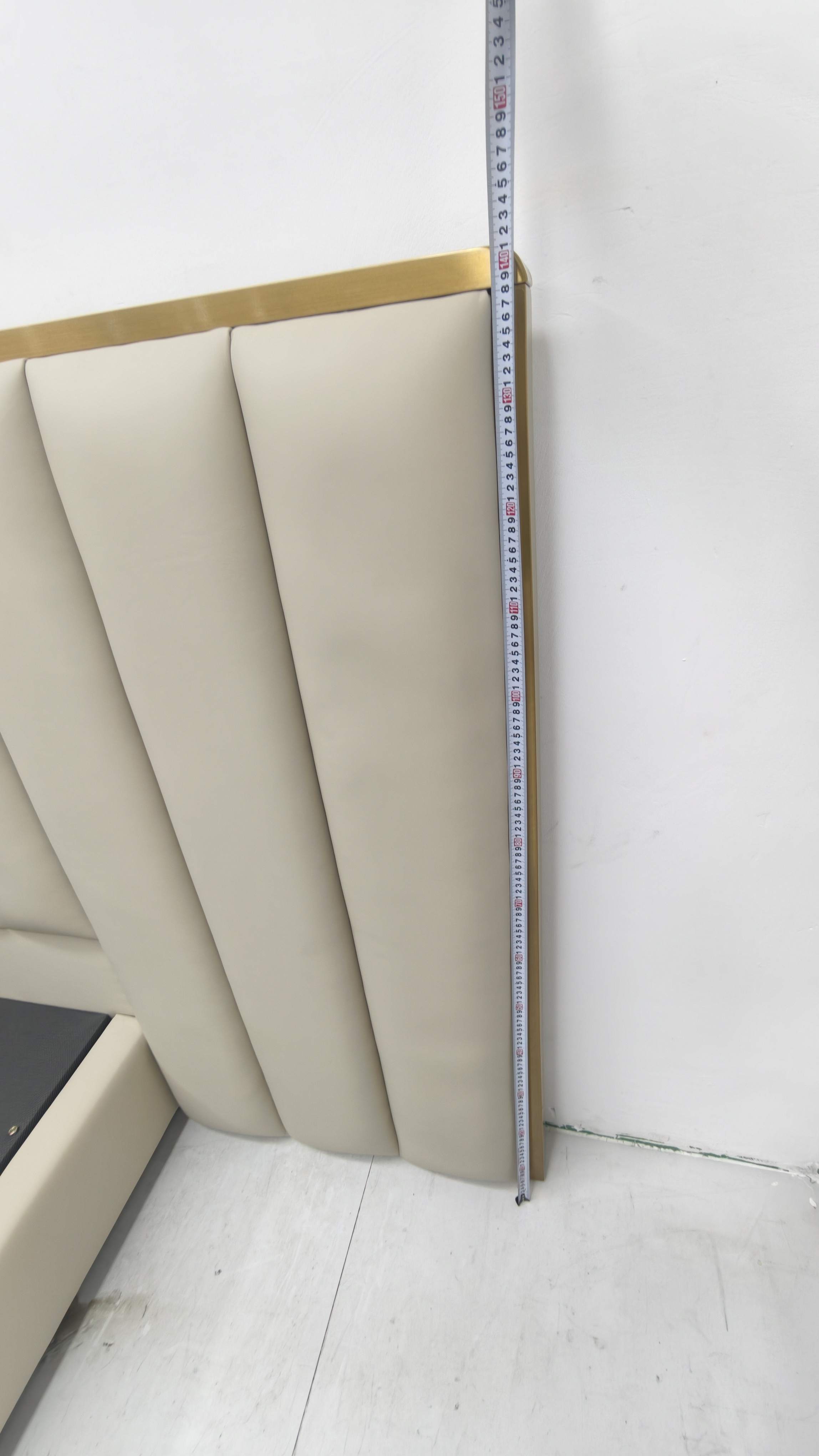 Tape measure alongside a padded headboard in the Lenatees physical-product archive