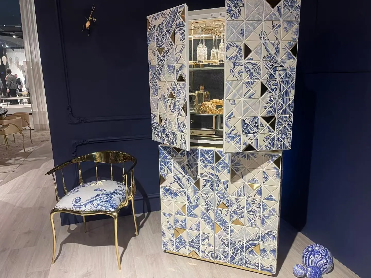 Blue and white Chinoiserie-inspired cabinet with matching accent chair