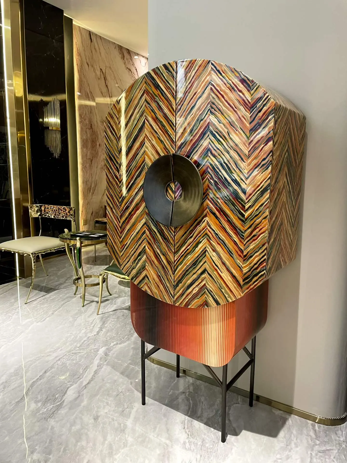 Tall custom cabinet with multicolor decorative surface and circular hardware