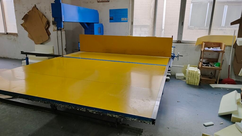 Foam cutting table with cut foam pieces in a workshop