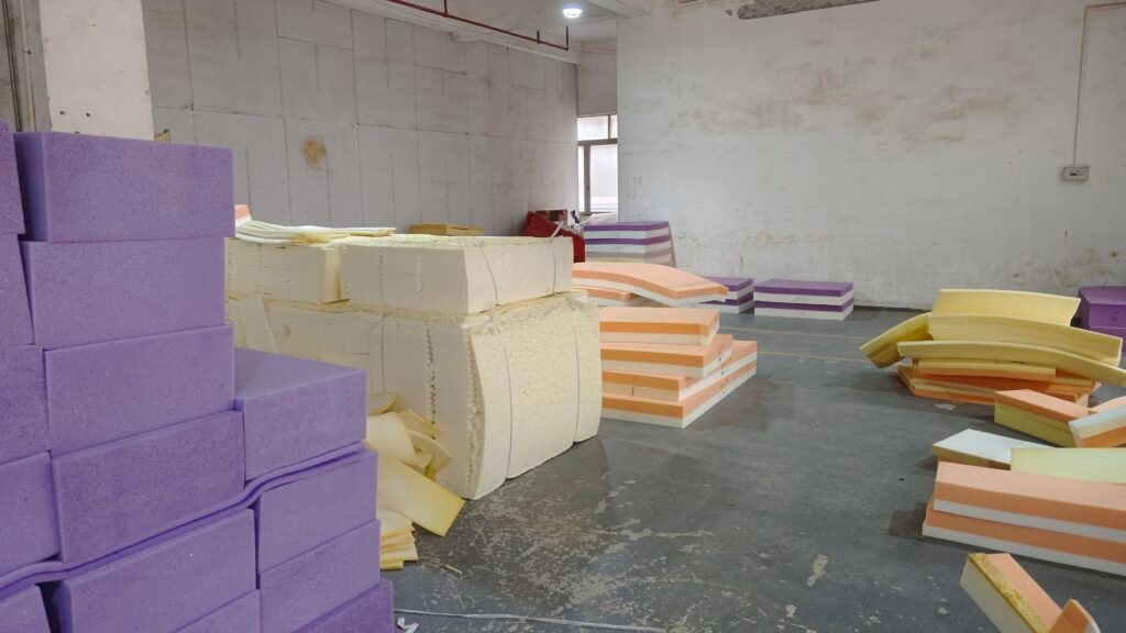 Foam blocks and layered cushion components arranged in a workshop