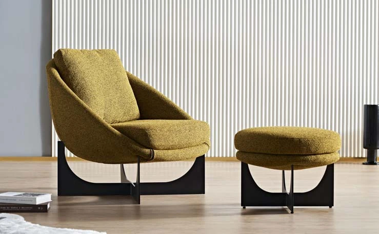 Mustard LC23-35 sculptural lounge chair with a curved shell and dark geometric base shown beside a round ottoman