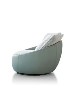 Side view of the LC23-41 rounded lounge chair with a pale green shell, light cushions and a low dark circular base