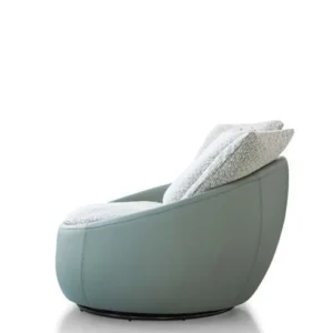Side view of the LC23-41 rounded lounge chair with a pale green shell, light cushions and a low dark circular base