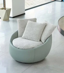 Front view of the pale green LC23-41 lounge chair showing its rounded shell and layered light cushions