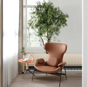 Brown LC24-04 lounge armchair with a curved high back, padded armrests and dark exposed legs beside a window