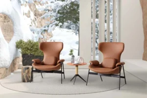 Two brown LC24-04 high-back lounge armchairs arranged around a small table in a window lounge