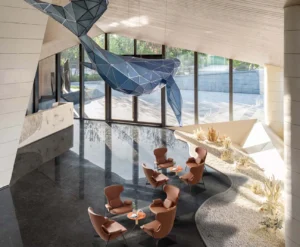 Groups of LC24-04 lounge armchairs arranged around small tables in a spacious indoor atrium