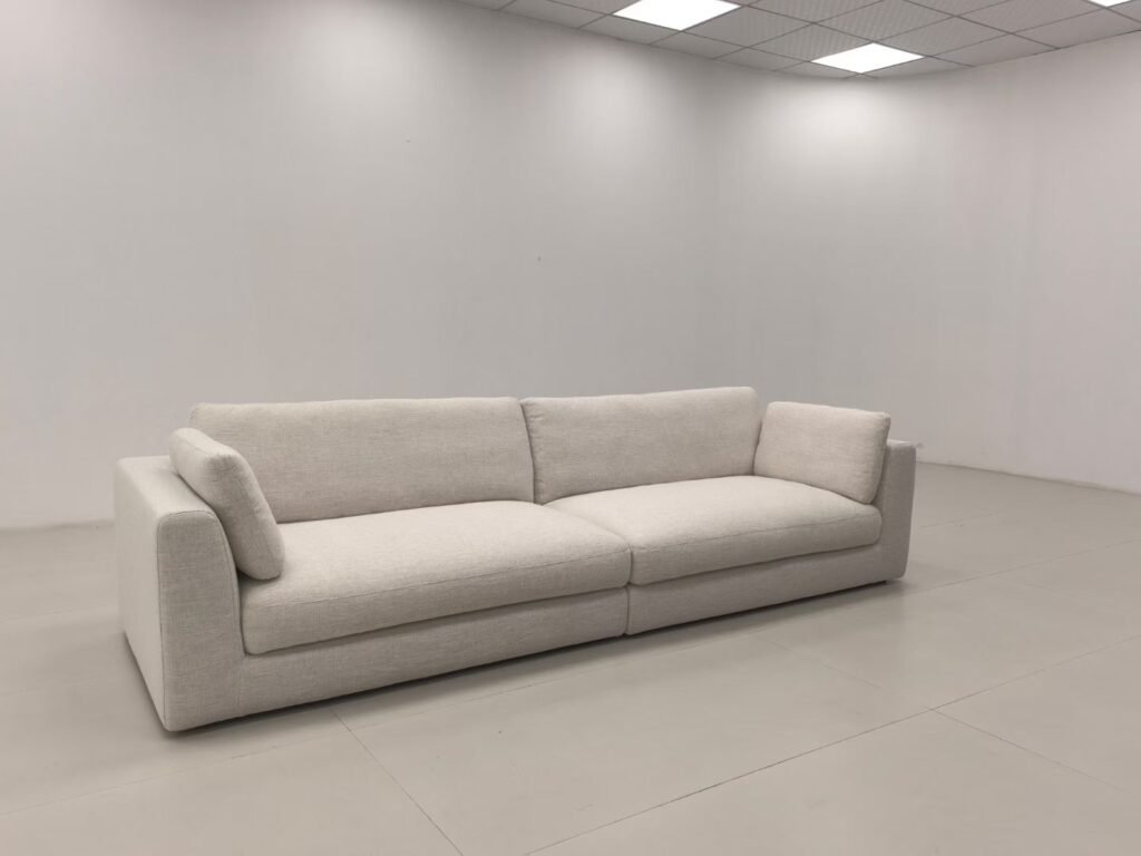 Off-white sofa with textured upholstery, two seat cushions and visible seams